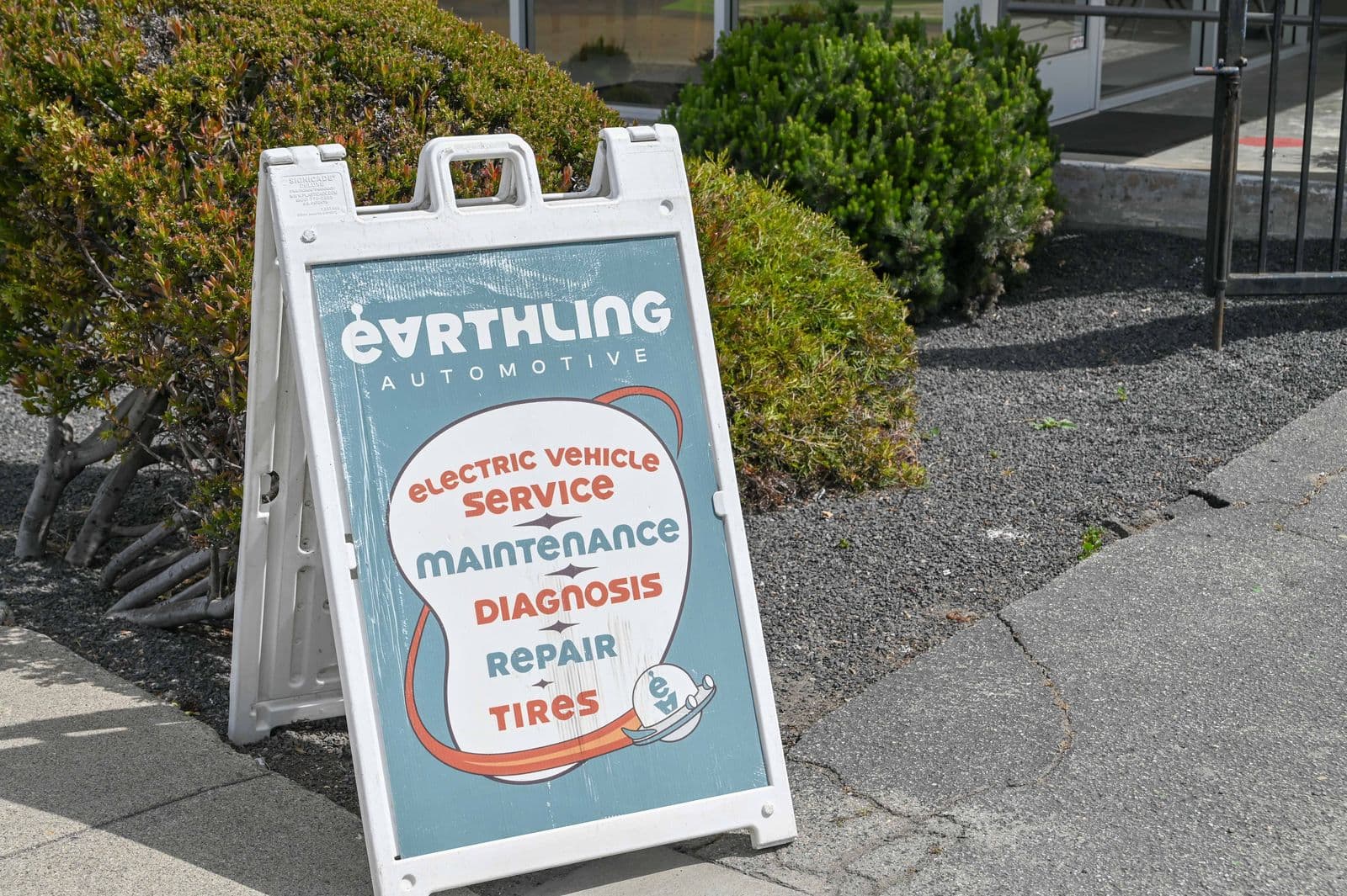 The Earthling sandwich board out front: electric vehicle service, maintenance, diagnosis, repair, tires